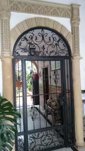 an entrance to a house with a wrought iron gate at Pensión Los Arcos in Córdoba