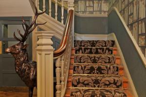 a set of stairs leading up to a stair case at The Crown Manor House Hotel in Lyndhurst