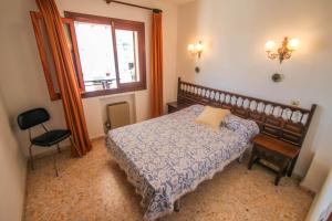 a bedroom with a bed and a window and a chair at Fustera Pedros - old-style country house in Benissa in Benissa +19 photos