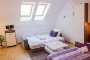 a small room with a bed and a table at MTM apartment in Bled