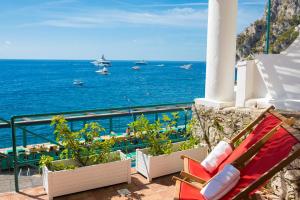 a bench on a balcony overlooking the ocean at Diva La Canzone Del Mare in Capri