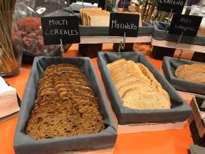 three different types of bread in trays on a table at Hotel Europa Jaén in Jaén