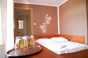 a bedroom with a bed and a table with a glass tray at Koral in Koszalin
