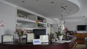 a bar in a restaurant with flowers on the counter at Koral Dom Gościnny in Koszalin