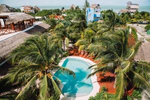 an aerial view of a resort with a pool and palm trees at Ensueño Holbox & Beach Club in Holbox Island