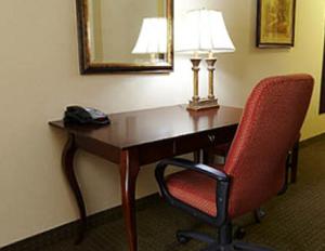 a desk in a hotel room with a chair and a mirror at Holiday Inn Express & Suites Lexington North West-The Vineyard, an IHG Hotel in Lexington