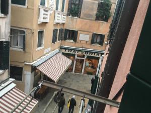 an overhead view of a street with people walking in front of a building at Majoorel (near San Marco) in Venice