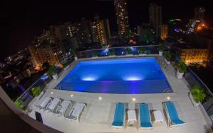 a swimming pool on top of a building at night at Hotel Tayrona del Mar in Santa Marta