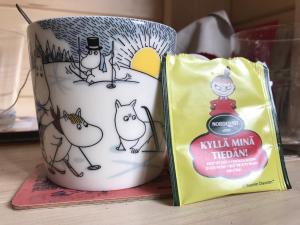 a coffee mug with cats on it next to a bag at Rifugio Manfre in Belpasso