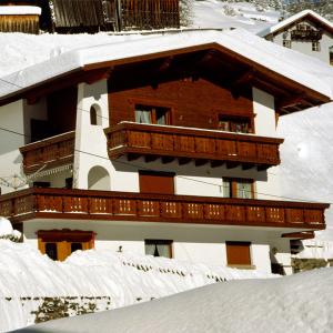 a building with a balcony on top of snow covered roofs at Apart Piz Palü Kappl/Ischgl in Kappl