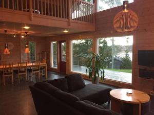 a living room with a couch and a table at Rundbergs Stugor in Kungsö