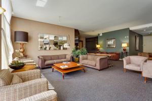 a living room with couches and chairs and a table at Kuster Hotel in Guarapuava