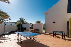 a ping pong table on top of a patio at Arpaso in Costa Teguise