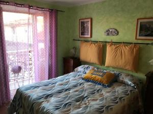 a bedroom with a bed with pillows and a window at Borgo La Forgia in Roccasicura