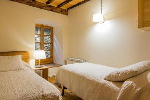 A bed or beds in a room at Casa Rural "Casa Chin", Val d'Aran