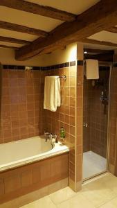 a bathroom with a bath tub and a shower at Queens Head Inn & Restaurant in Hawkshead