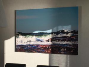 a painting of the ocean on a wall at Villa Solstrand in Fagerlund