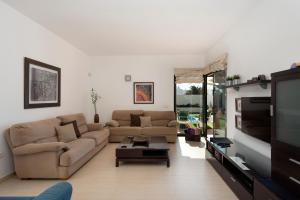 a living room with two couches and a flat screen tv at Arpaso in Costa Teguise