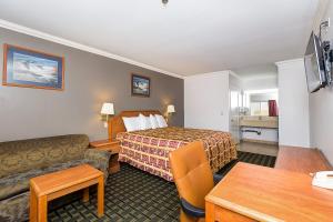 a hotel room with a bed and a couch at Buena Vista Inn in Anaheim