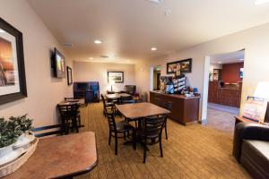 a room with tables and chairs and a living room at My Place Hotel-Cheyenne, WY in Cheyenne