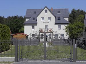 una puerta frente a una casa blanca en Willa Ballada, en Kuźnica