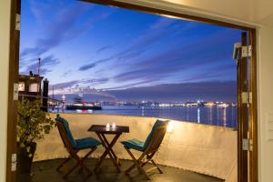 a balcony with a table and chairs and a view of the water at M/S Svalbard B&B in Amsterdam