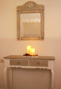 a table with a candle and a mirror at Kleanthe in Halki