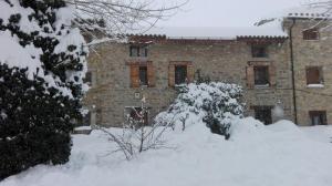 a building with snow in front of it at Casa Maria Jesus in Mosqueruela