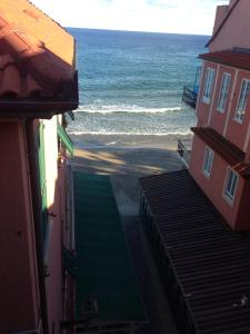 a view of the ocean from between two buildings at Attico Fronte Mare Alassio in Alassio