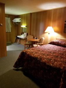 a hotel room with a bed and a desk at Buckhorn Resort in Munising