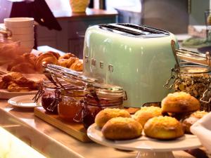 a toaster sitting on top of a counter with pastries at Dear Lisbon - Bordalo Palace Chiado in Lisbon