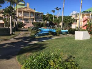 une piscine dans une cour à côté d'une maison dans l'établissement Studio Anse des Rochers, à Saint-François
