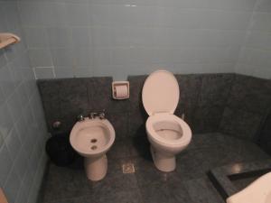a bathroom with a toilet and a bidet at Hotel El Circulo in Mar del Plata +40 photos