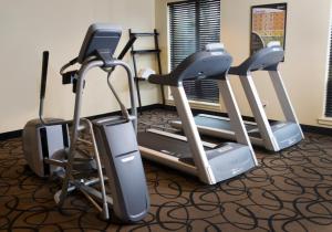 a gym with three exercise bikes and a treadmill at Aspen Suites Hotel Sitka in Sitka