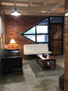 a living room with a couch and a coffee table at Rareheart Guesthouse in Kuala Terengganu