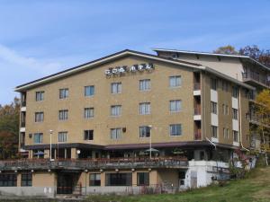 a building with bikes on the top of it at Biwaike Hotel in Yamanouchi