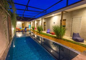 a swimming pool in a building with a swimming pool at Surfer Garden in Sanur