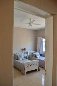um quarto com 2 camas e uma ventoinha de tecto em Altos de Artusi em Concepción del Uruguay