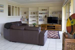 a living room with a couch and a flat screen tv at Casa Al Lago in Montville