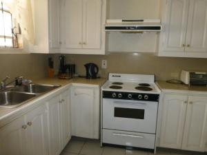 a kitchen with a white stove and a sink at Hastings Towers 3B Opp Sea 2 Bed 2 Bath in Bridgetown