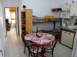 a kitchen with a table and chairs in a room at MarWal Departamentos in Santa Teresita