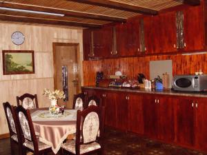 a kitchen with a table with chairs and a microwave at Стожари in Verkhovyna