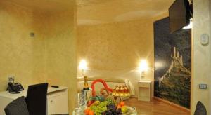 una sala da pranzo con tavolo e un dipinto sul muro di I Rocchi Hotel a Tito