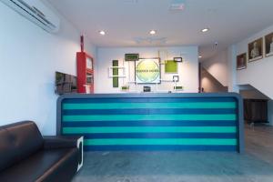 a lobby with a blue counter in a room at Clover Hotel Ipoh in Ipoh