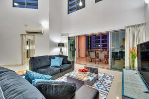 a living room with a couch and a table at Argus Apartments Darwin in Darwin