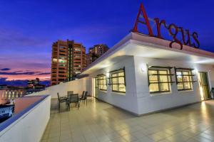 a building with chairs on the roof at night at Argus Apartments Darwin in Darwin