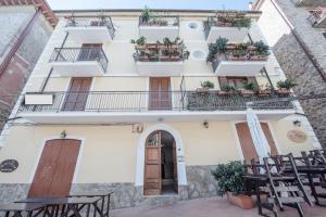 a building with tables and chairs in front of it at Casa vacanze Maria in Agropoli