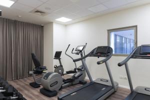 a gym with treadmills and ellipticals in a room at Leonardo Boutique Jerusalem in Jerusalem