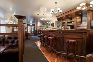 a bar with red stools in a room at Hotel Gilleleje Strand in Gilleleje