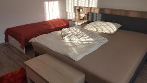 a room with two beds and a table with a bedskirts at Ferienhaus Karall in Klingenbach